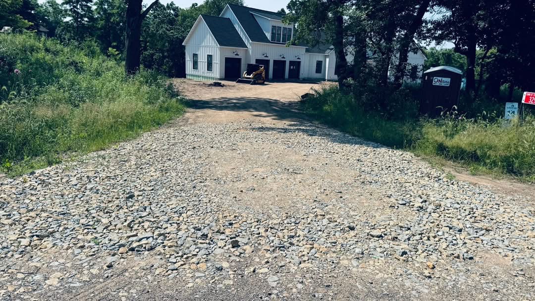 Fresh gravel driveway leading to new home